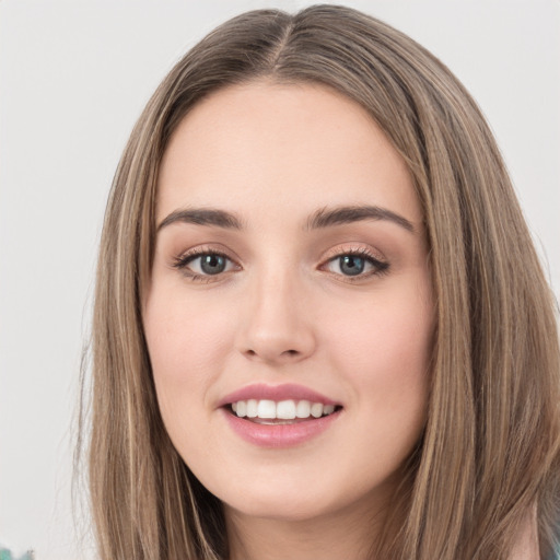 Joyful white young-adult female with long  brown hair and green eyes