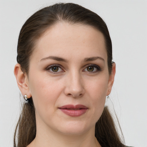 Joyful white young-adult female with long  brown hair and grey eyes