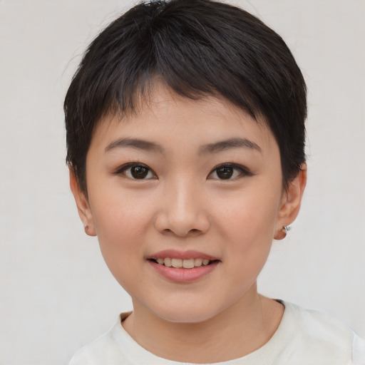 Joyful asian child female with short  brown hair and brown eyes