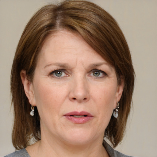 Joyful white adult female with medium  brown hair and grey eyes