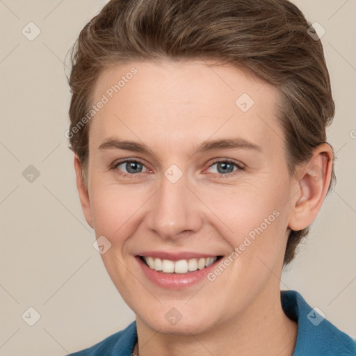 Joyful white young-adult female with short  brown hair and grey eyes