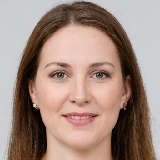 Joyful white young-adult female with long  brown hair and grey eyes