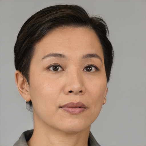 Joyful white adult female with short  brown hair and brown eyes