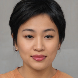 Joyful asian young-adult female with medium  black hair and brown eyes