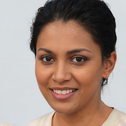 Joyful latino young-adult female with short  brown hair and brown eyes