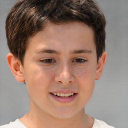 Joyful white child male with short  brown hair and brown eyes