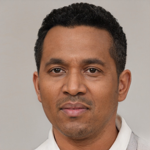 Neutral latino adult male with short  black hair and brown eyes