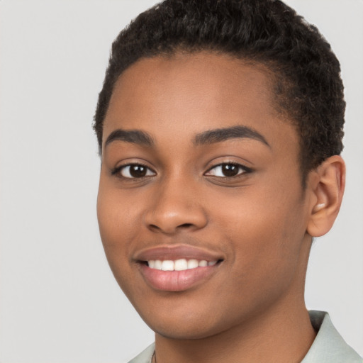 Joyful black young-adult female with short  brown hair and brown eyes