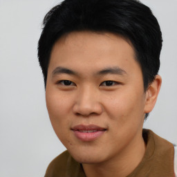 Joyful asian young-adult male with short  black hair and brown eyes