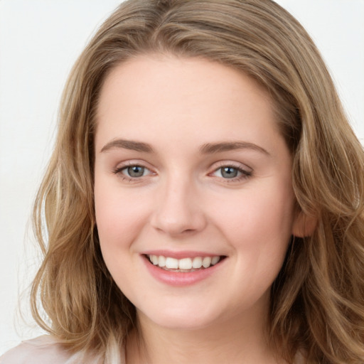 Joyful white young-adult female with long  brown hair and green eyes