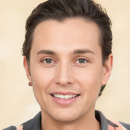 Joyful white young-adult male with short  brown hair and brown eyes