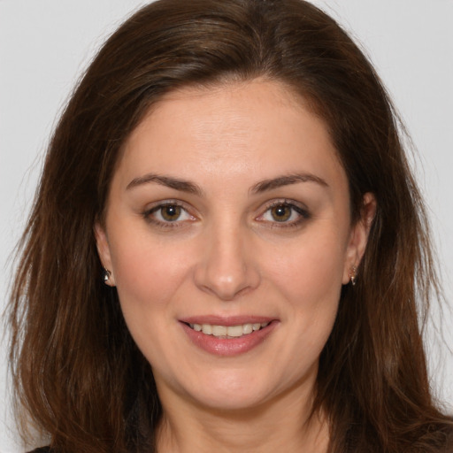 Joyful white young-adult female with long  brown hair and brown eyes