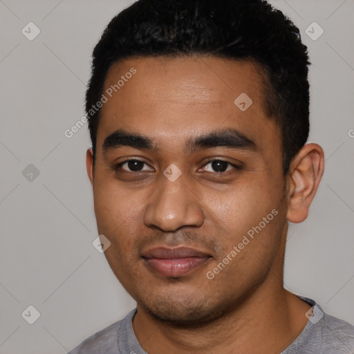 Joyful black young-adult male with short  black hair and brown eyes