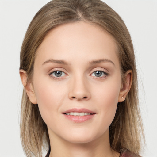 Joyful white young-adult female with long  brown hair and blue eyes