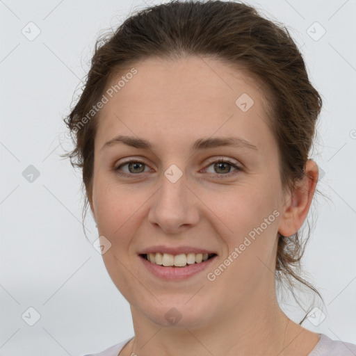 Joyful white young-adult female with medium  brown hair and grey eyes