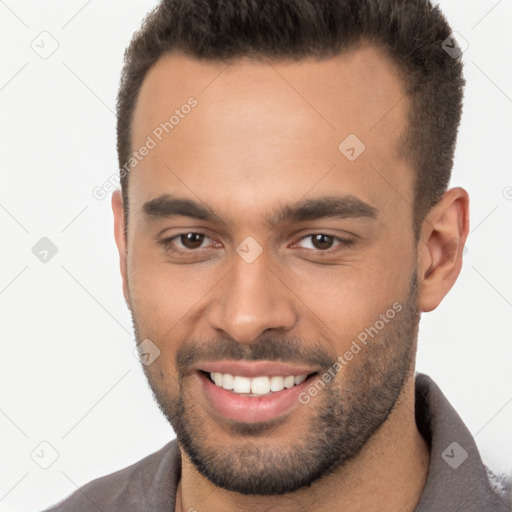 Joyful white young-adult male with short  brown hair and brown eyes