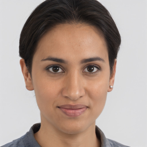 Joyful latino young-adult female with medium  brown hair and brown eyes