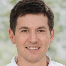 Joyful white young-adult male with short  brown hair and brown eyes