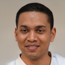 Joyful latino young-adult male with short  black hair and brown eyes