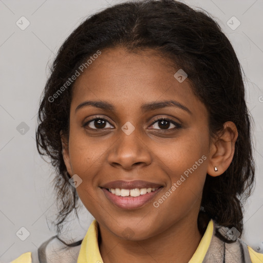 Joyful black young-adult female with long  brown hair and brown eyes