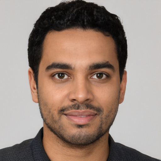 Joyful latino young-adult male with short  black hair and brown eyes