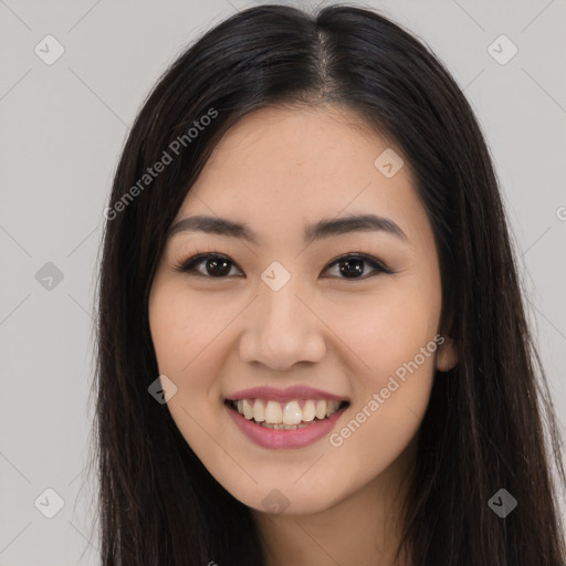 Joyful asian young-adult female with long  brown hair and brown eyes