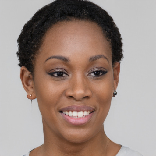 Joyful black young-adult female with short  brown hair and brown eyes