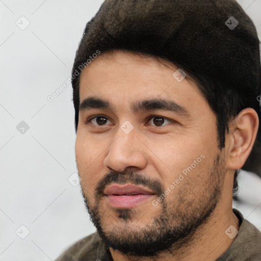 Joyful latino young-adult male with short  black hair and brown eyes