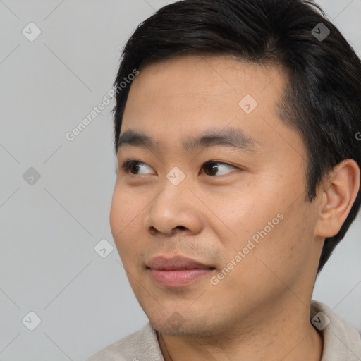 Joyful asian young-adult male with short  brown hair and brown eyes