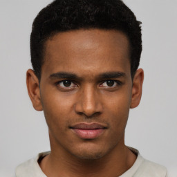 Joyful black young-adult male with short  black hair and brown eyes