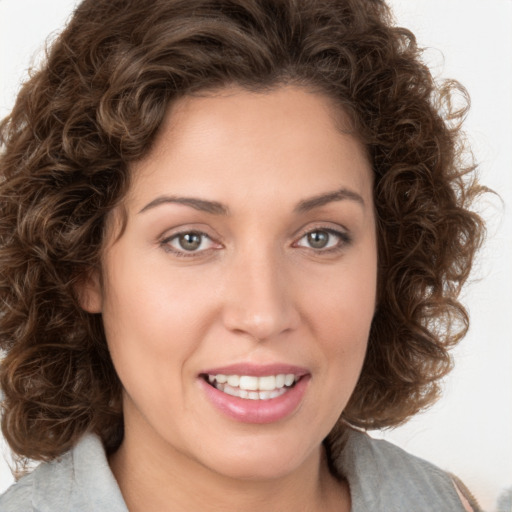 Joyful white young-adult female with medium  brown hair and green eyes