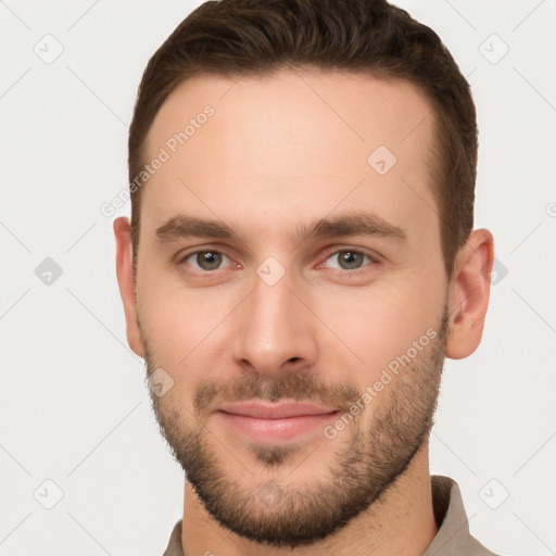 Joyful white young-adult male with short  brown hair and brown eyes