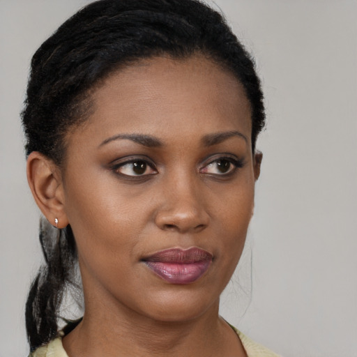Joyful black young-adult female with short  brown hair and brown eyes