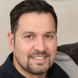 Joyful white adult male with short  brown hair and brown eyes