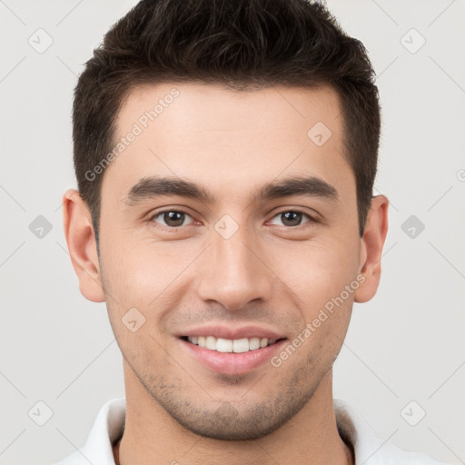 Joyful white young-adult male with short  brown hair and brown eyes