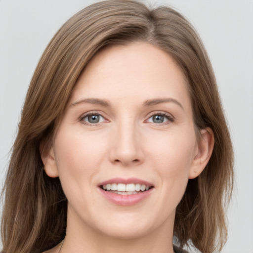 Joyful white young-adult female with medium  brown hair and grey eyes