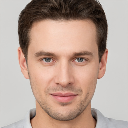 Joyful white young-adult male with short  brown hair and brown eyes