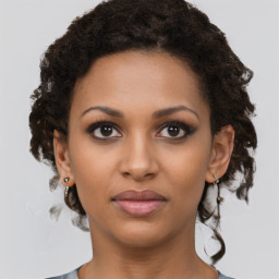 Joyful black young-adult female with short  brown hair and brown eyes