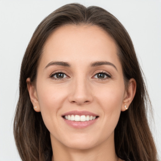 Joyful white young-adult female with long  brown hair and grey eyes