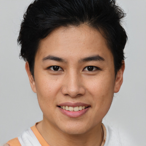 Joyful asian young-adult female with short  brown hair and brown eyes