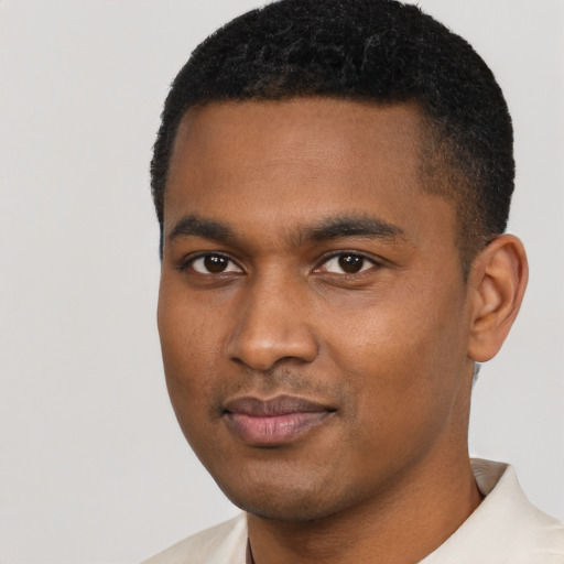 Joyful black young-adult male with short  black hair and brown eyes