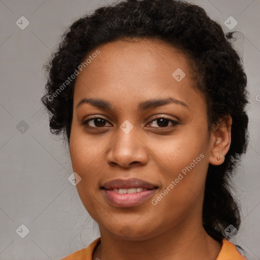 Joyful black young-adult female with long  brown hair and brown eyes