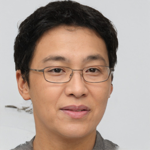 Joyful asian adult male with short  brown hair and brown eyes