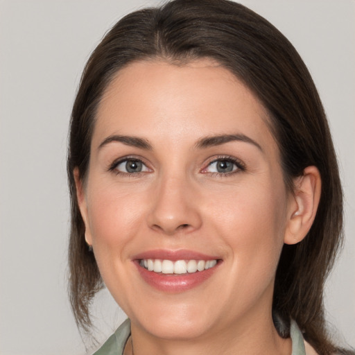 Joyful white young-adult female with medium  brown hair and brown eyes