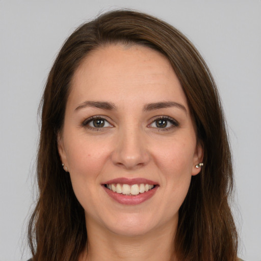 Joyful white young-adult female with long  brown hair and brown eyes