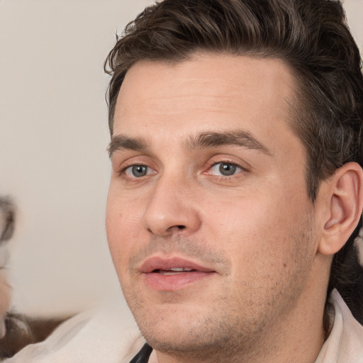 Joyful white young-adult male with short  brown hair and brown eyes