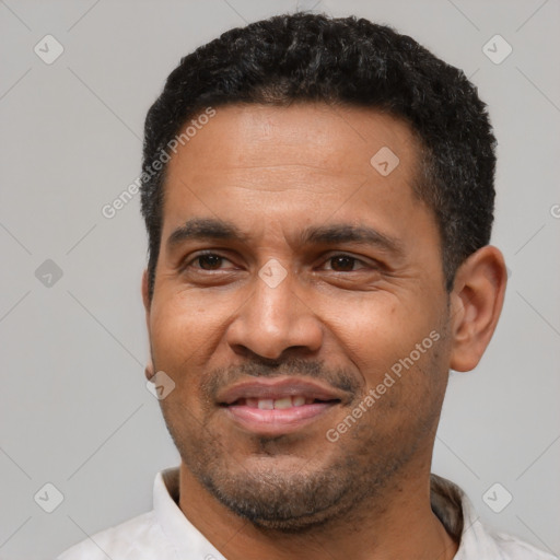 Joyful latino adult male with short  black hair and brown eyes