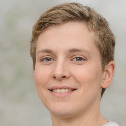 Joyful white young-adult female with short  brown hair and grey eyes