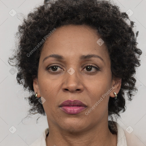 Joyful black adult female with medium  brown hair and brown eyes