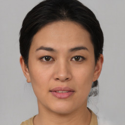 Joyful asian young-adult female with short  brown hair and brown eyes